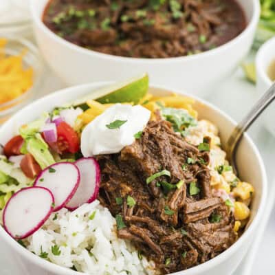 Burrito bowl topped with barbacoa and fresh radishes.