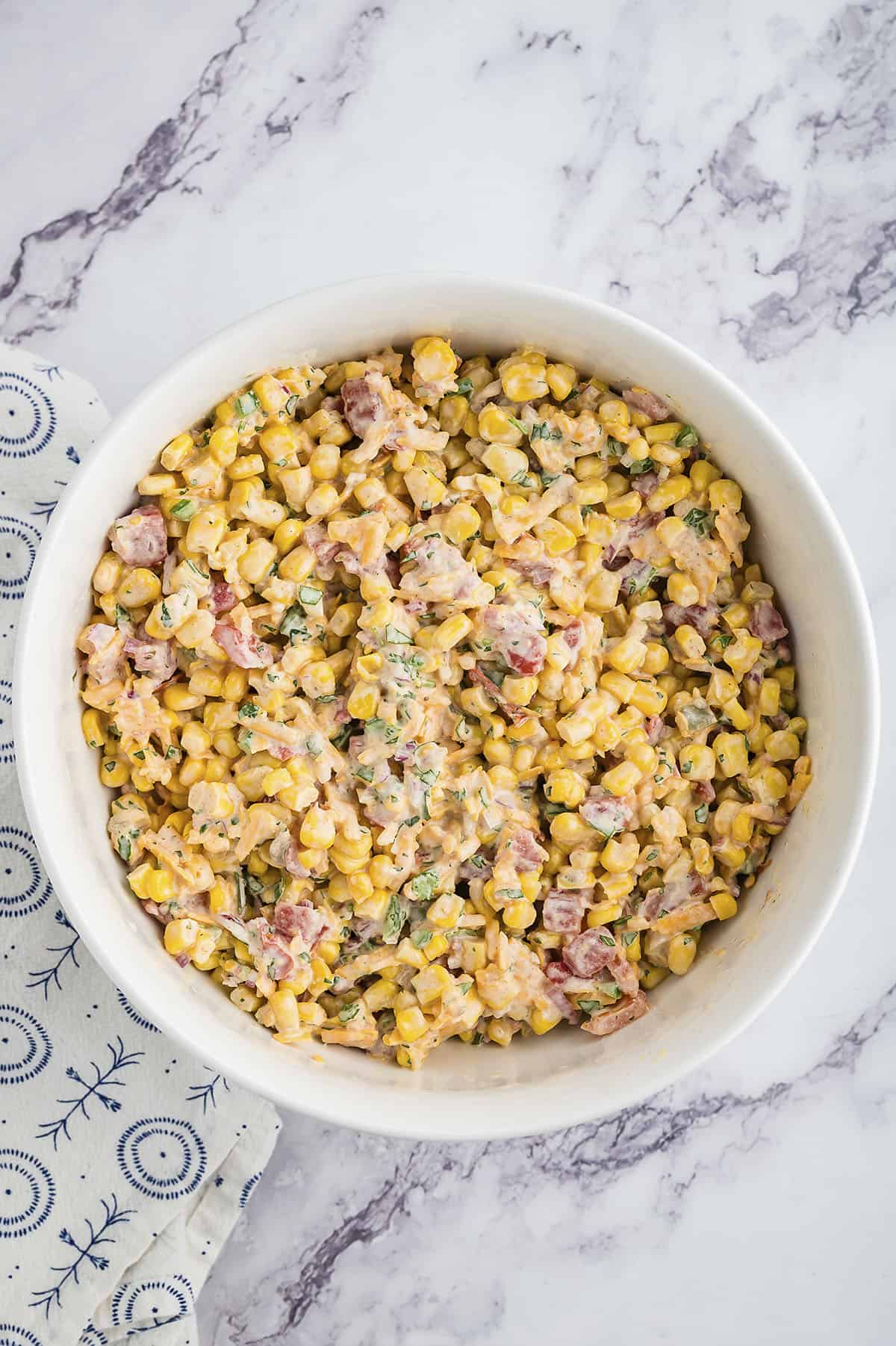 Cold corn dip in mixing bowl.