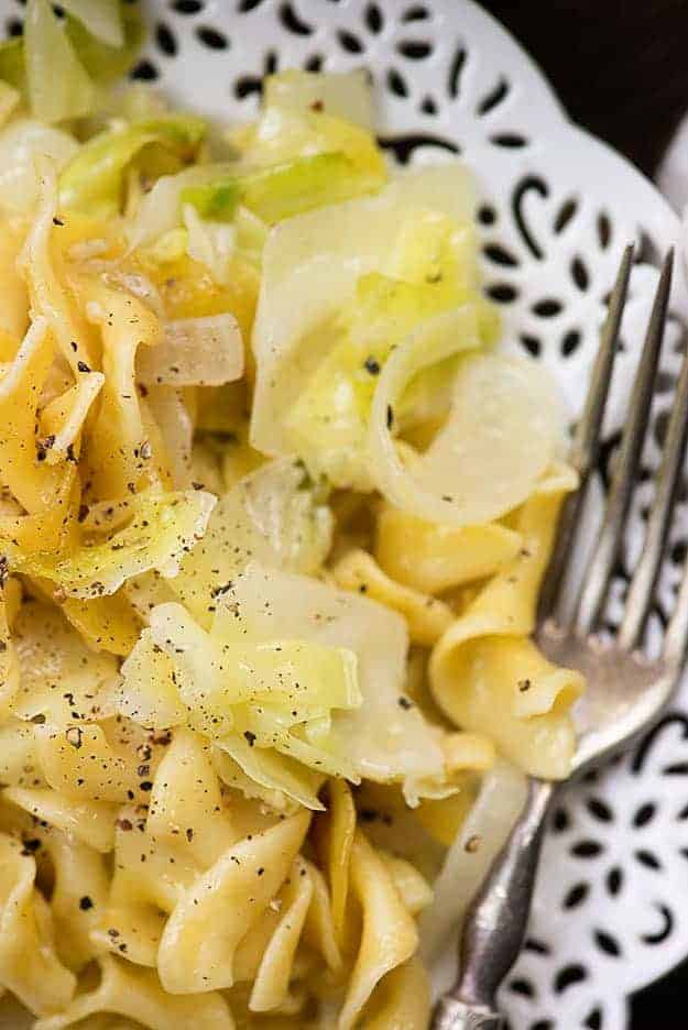 cabbage and noodles on white plate