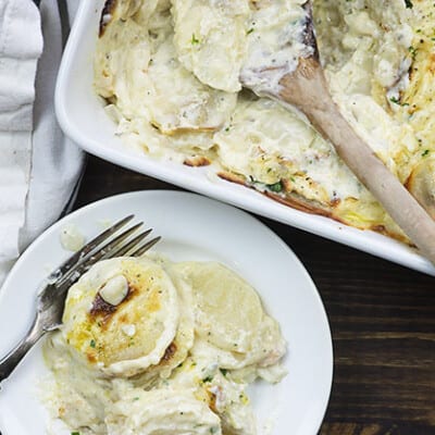 cheesy scalloped potatoes on white plate