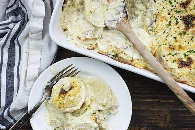 cheesy scalloped potatoes on white plate