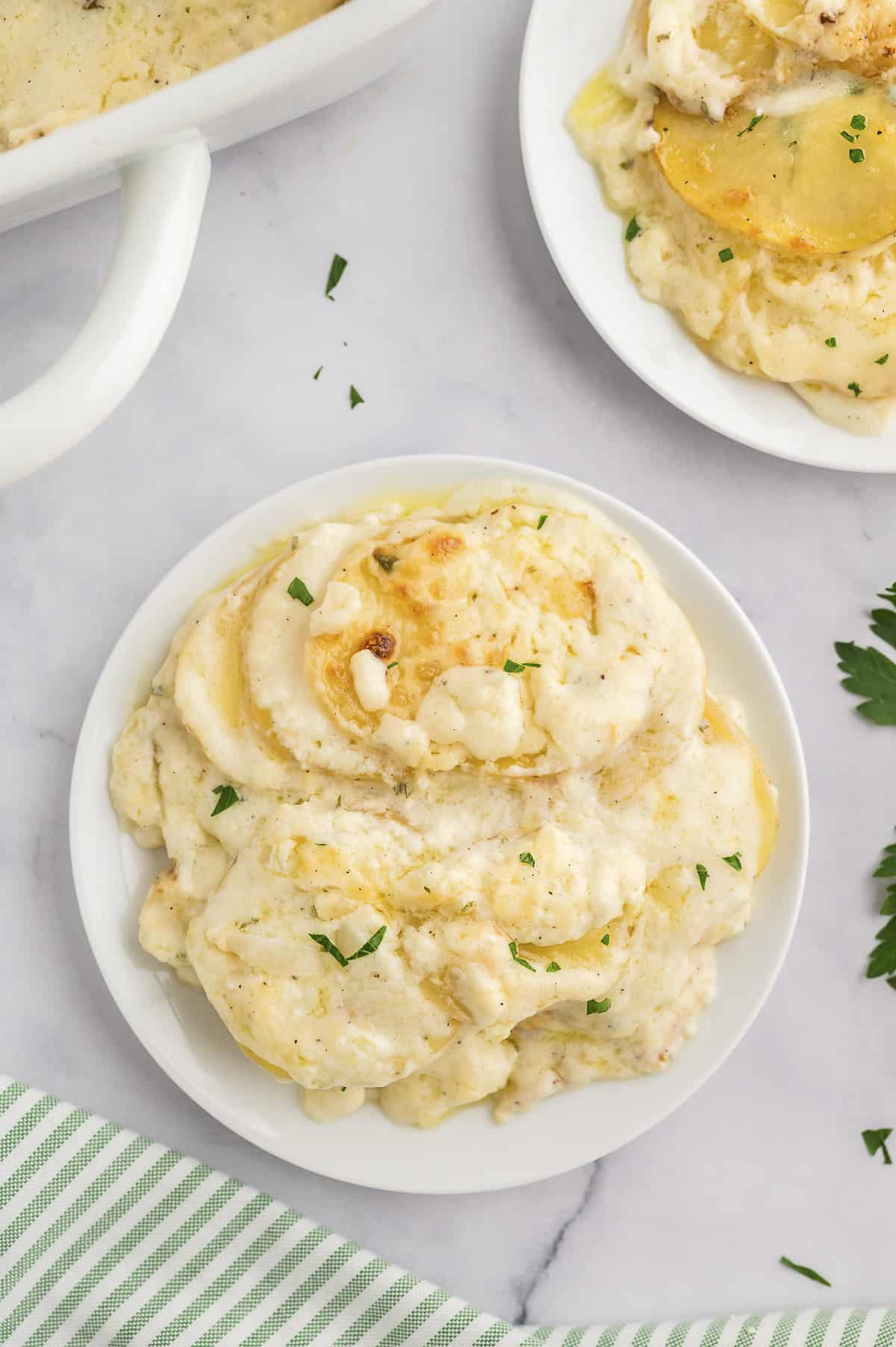 Plate full of homemade scalloped potatoes.