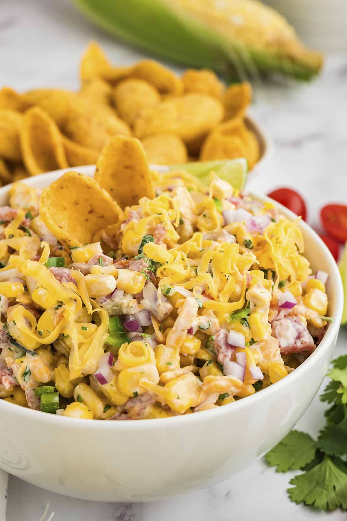 Corn dip in white serving bowl.