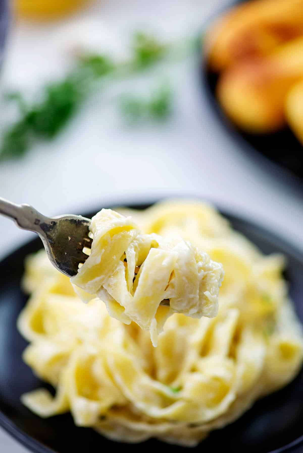 Fettucine Alfredo twirled on fork.