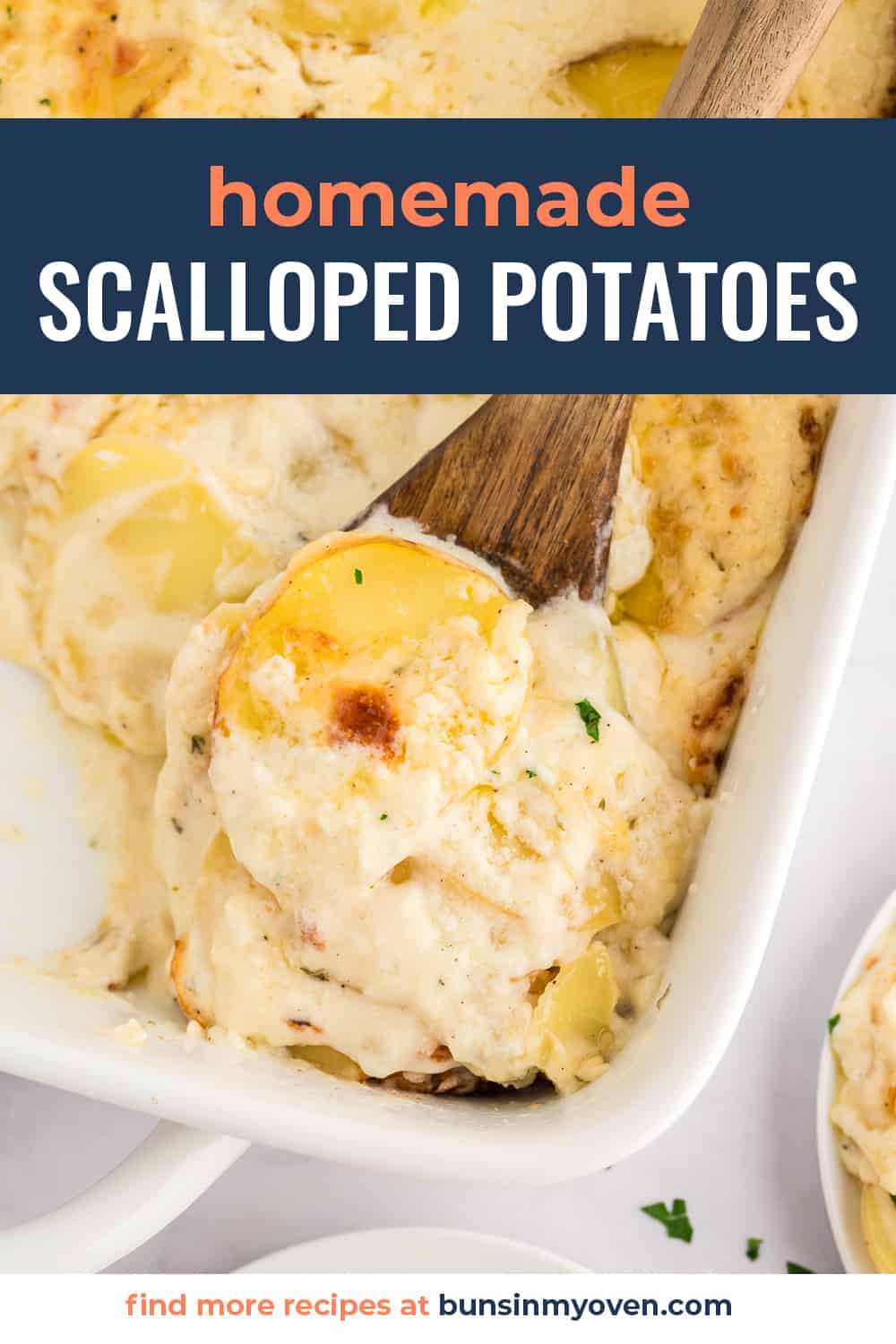 Scalloped potatoes on wooden spoon.