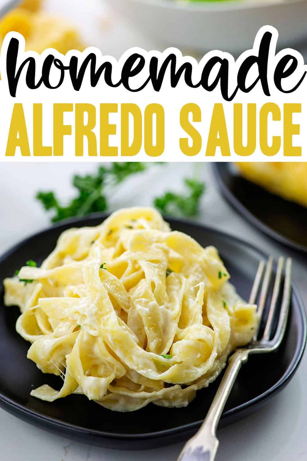 homemade Alfredo sauce on black plate.