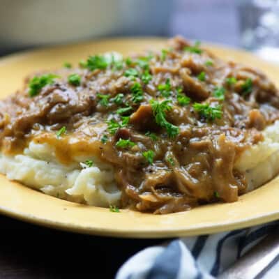 pork roast with gravy on yellow plate