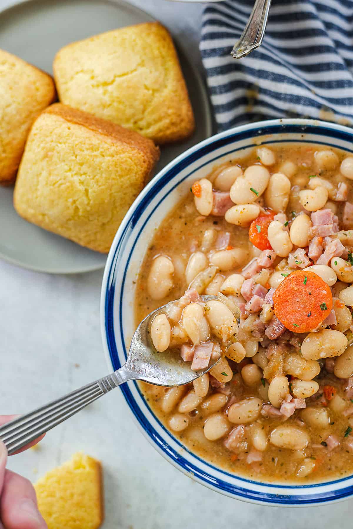 ham and bean soup on spoon.