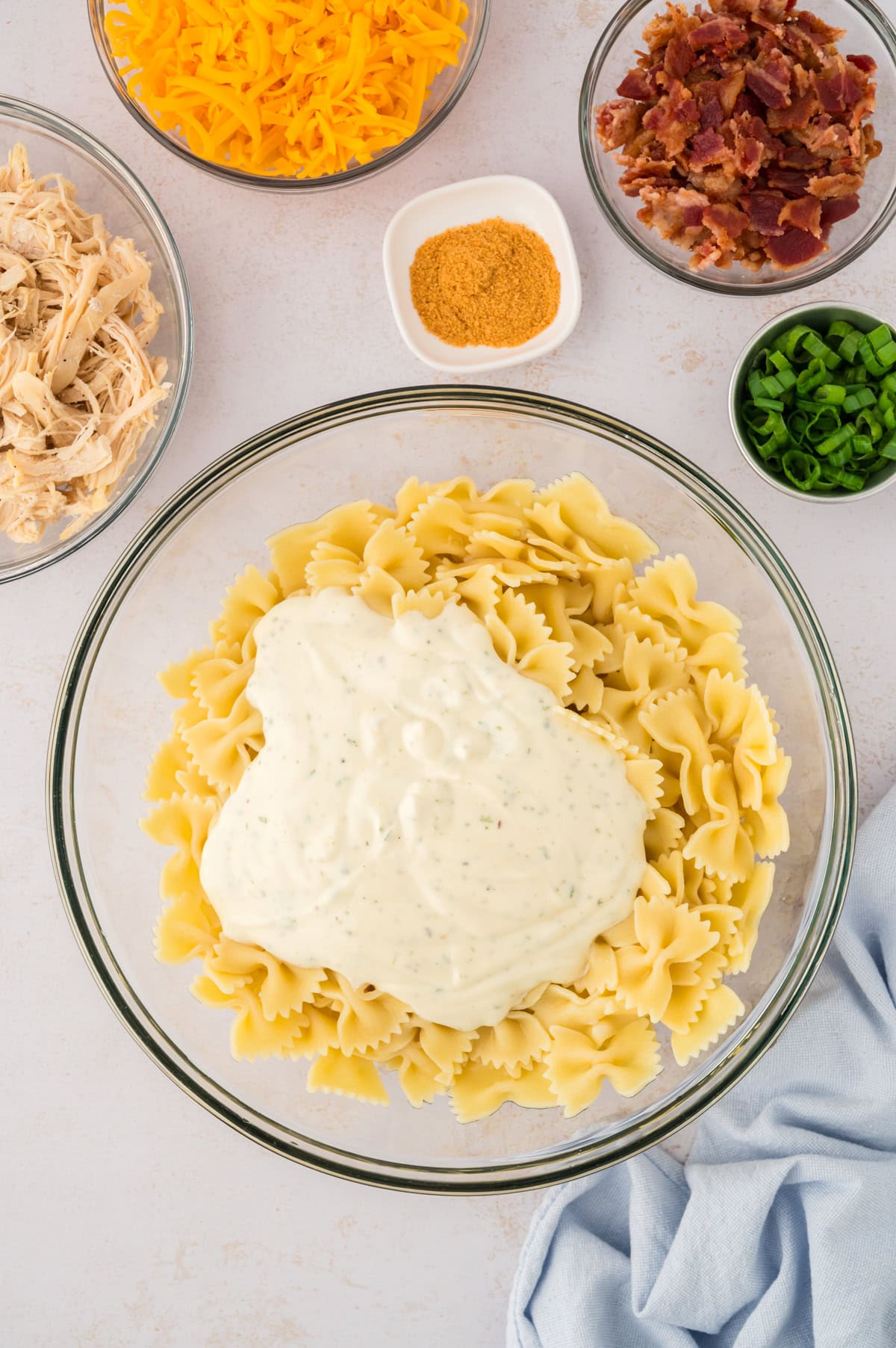 Cooked pasta topped with ranch.