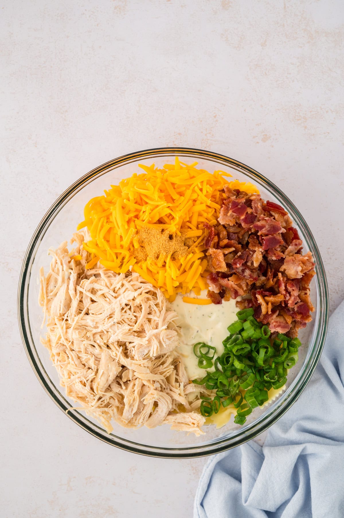 Chicken, bacon, cheddar, and ranch in bowl of pasta.