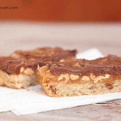 Caramel peanut butter candy bars on a paper napkin.