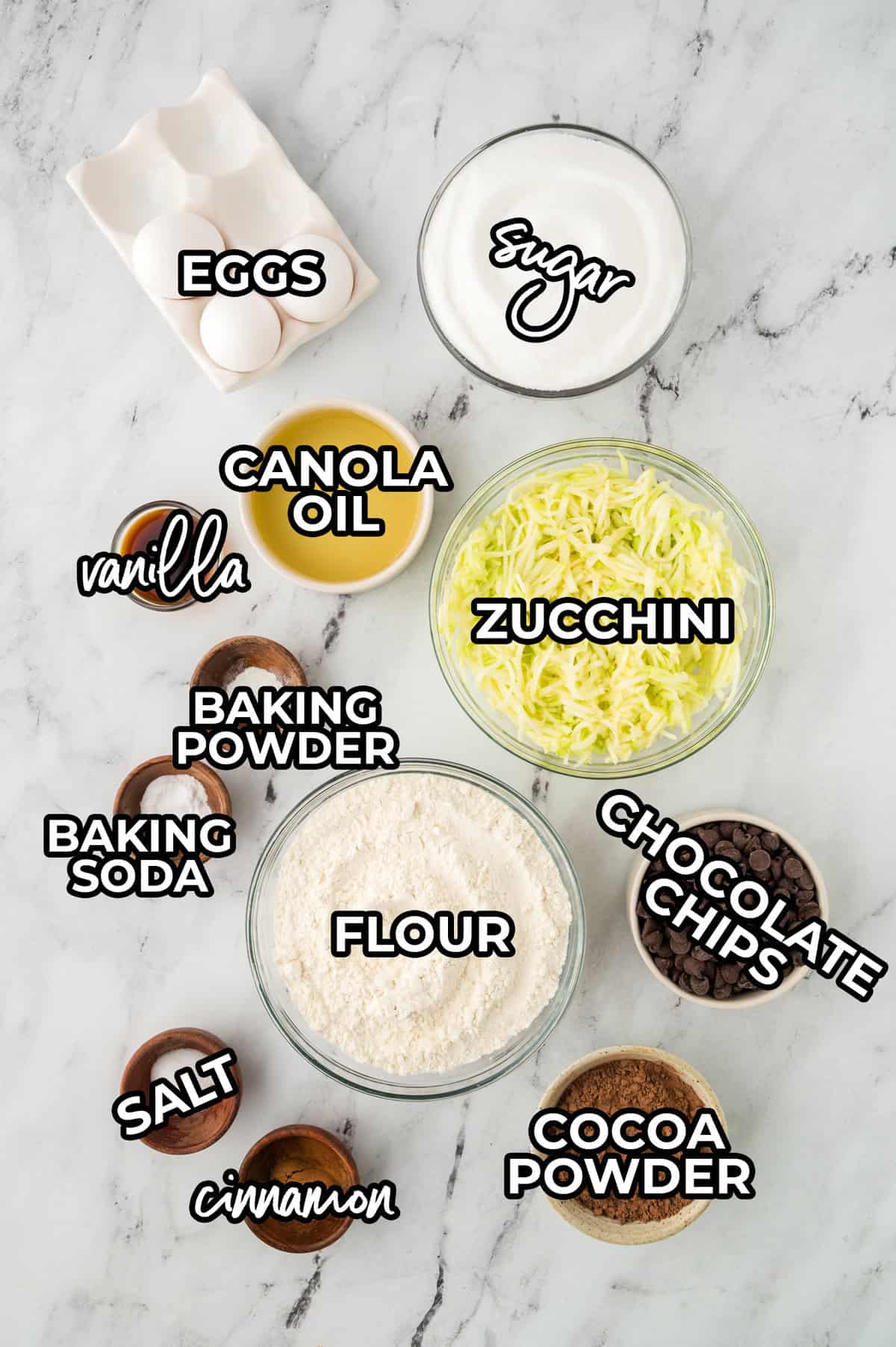 Ingredients for chocolate chocolate chip zucchini bread recipe on counter.