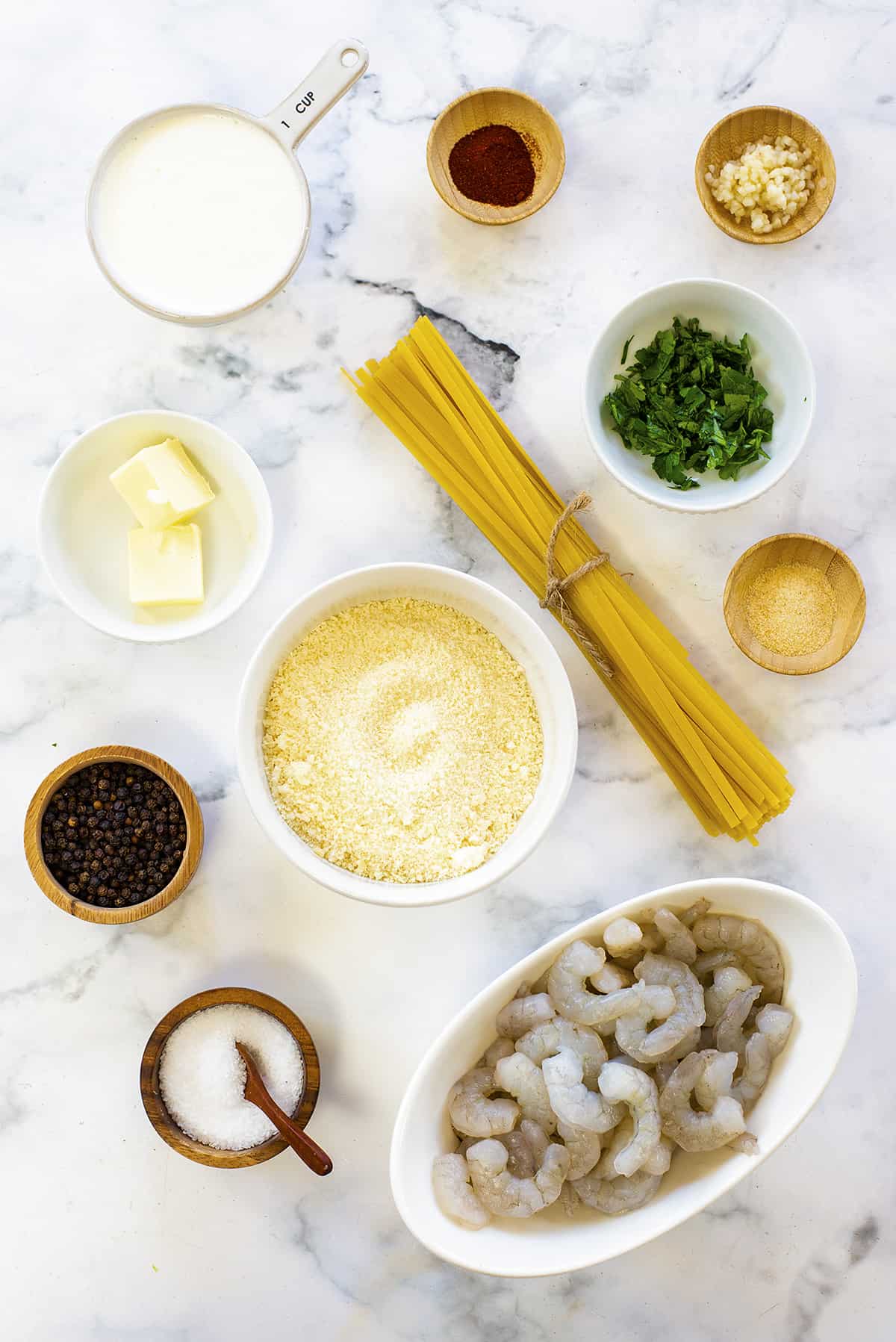 Ingredients for making shrimp alfredo at home.