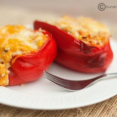 Two peppers stuffed with chicken and cheese.