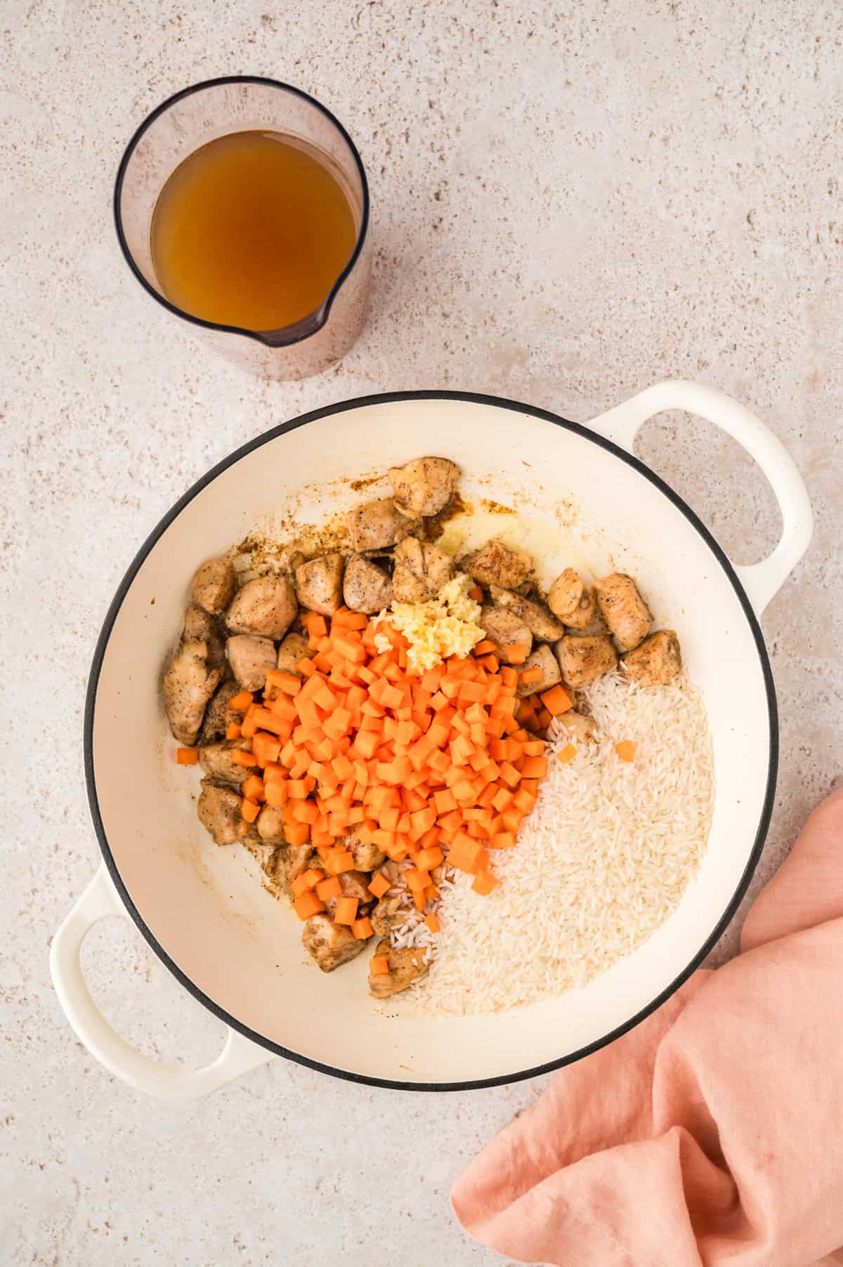 Carrots, rice, and chicken in skillet.