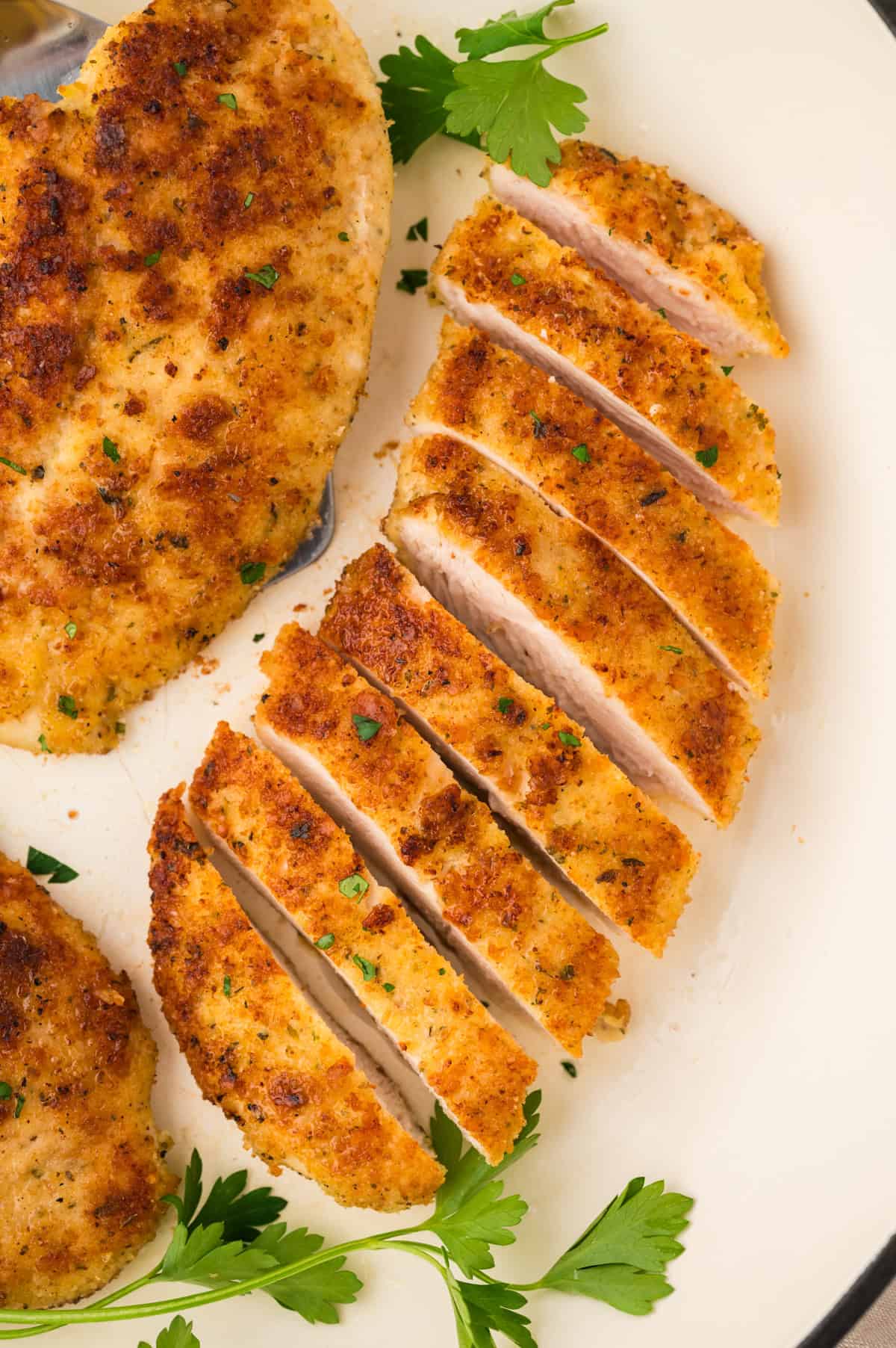 Sliced parmesan crusted chicken breasts.