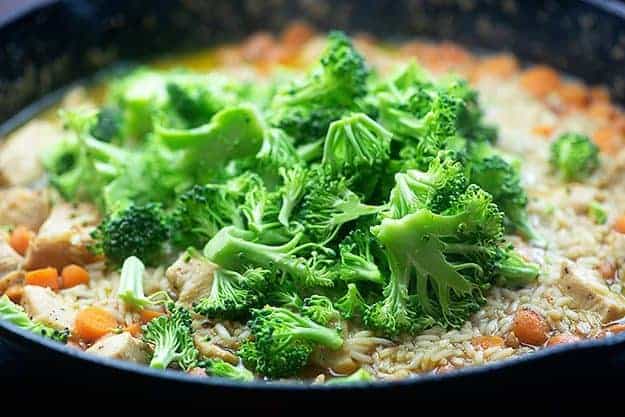 chicken and broccoli with rice in pan