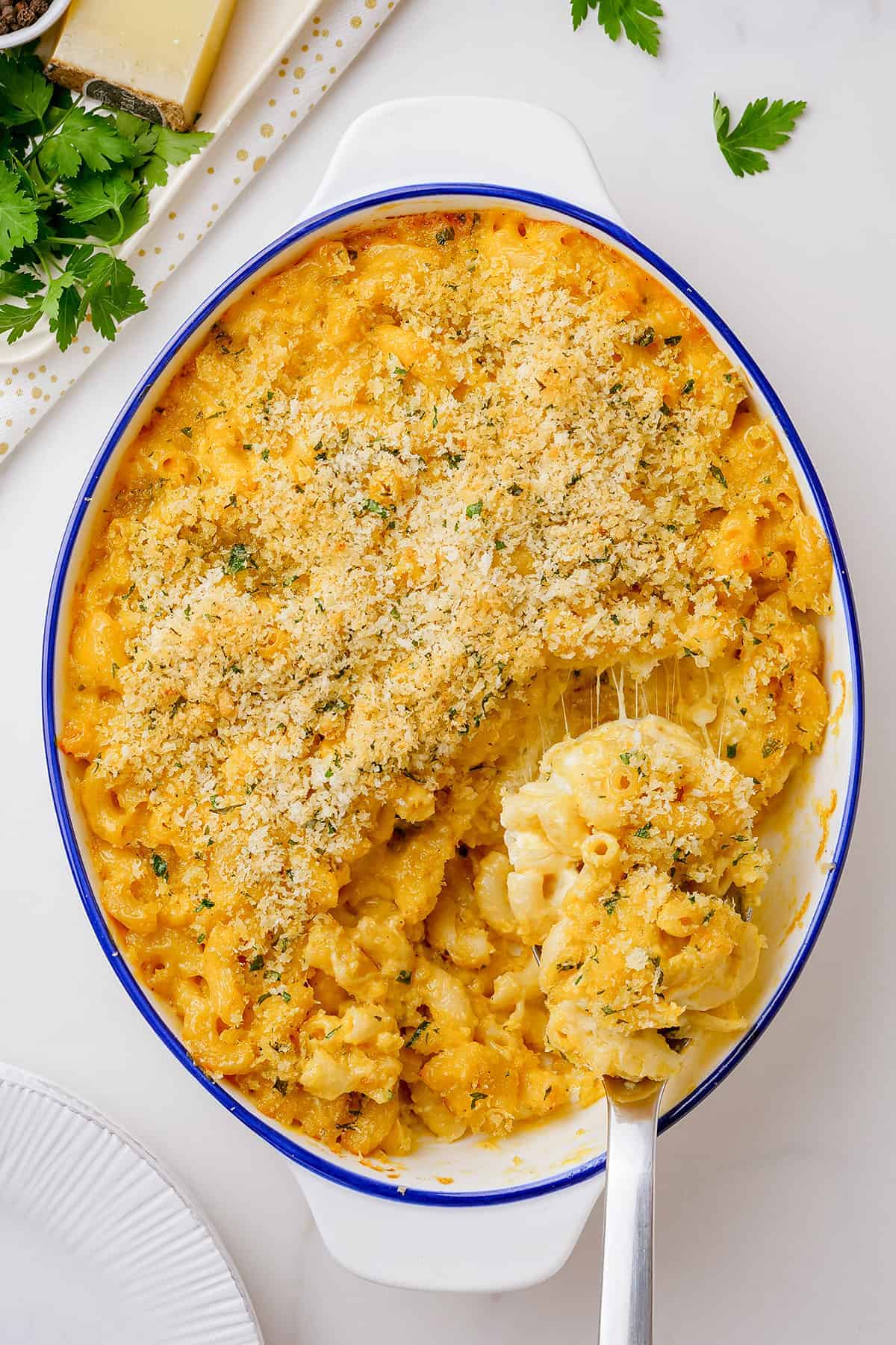 baked mac and cheese casserole in white baking dish.