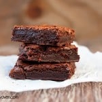 A stack of 3 brownies on a paper towel