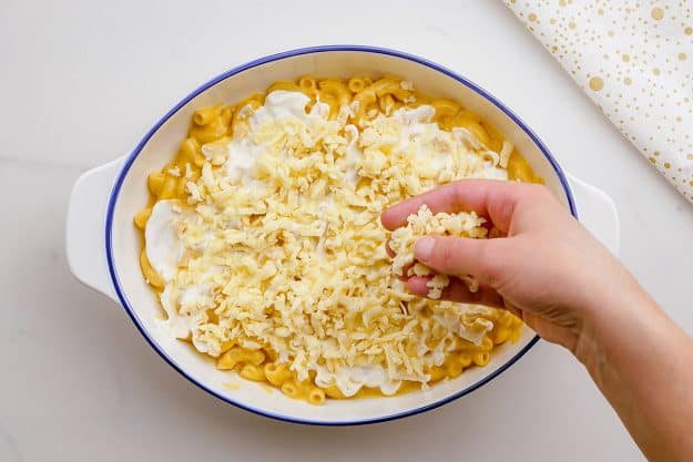 cheese being layered in casserole.