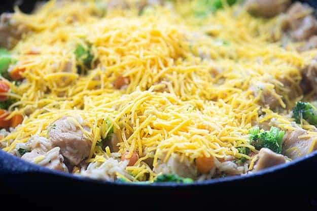 cheesy chicken and rice in cast iron skillet