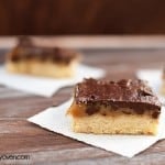 Chocolate caramel bars on napkins spread out on a table.