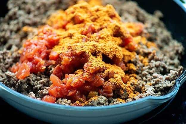 taco meat with tomatoes and chiles in white pan