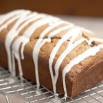 A loaf of maple cinnamon quick bread topped with icing.