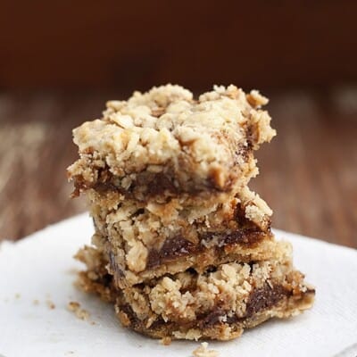 A stack of oatmeal bars on a square white plate.