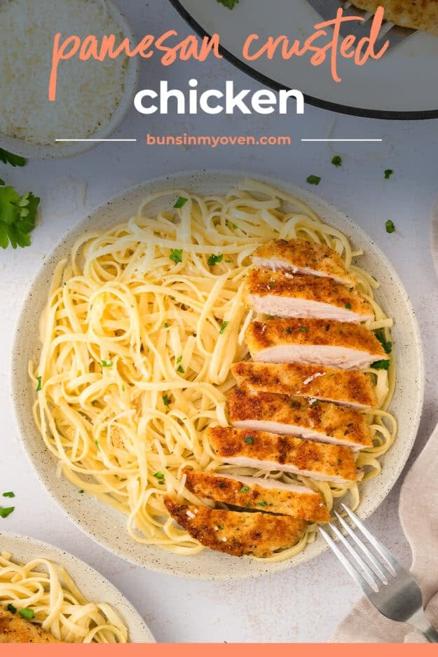 Parmesan chicken and creamy pasta on plate.