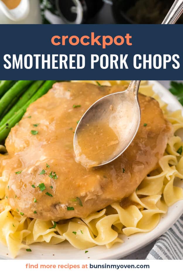 Spoon drizzling gravy over smothered pork chops.