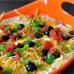 A close up of 7 layer dip in a serving pan.