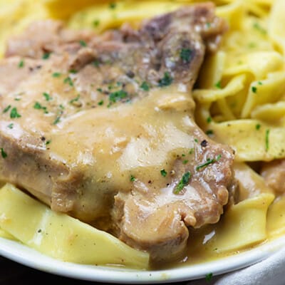 Pork chops on noodles.