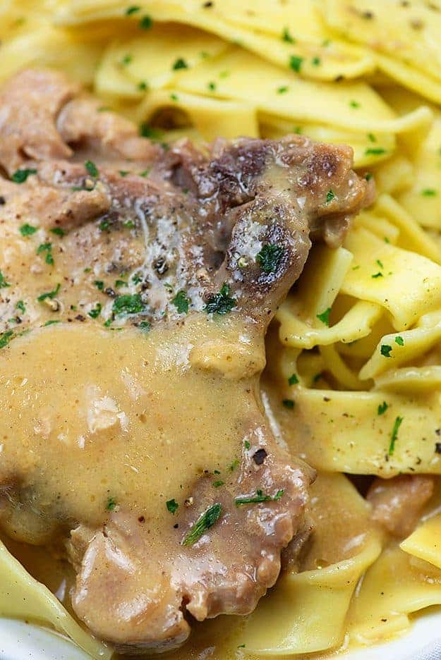 slow cooker pork chops smothered in gravy on egg noodles