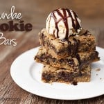A stack of cookie bars with a scoop of ice cream on top