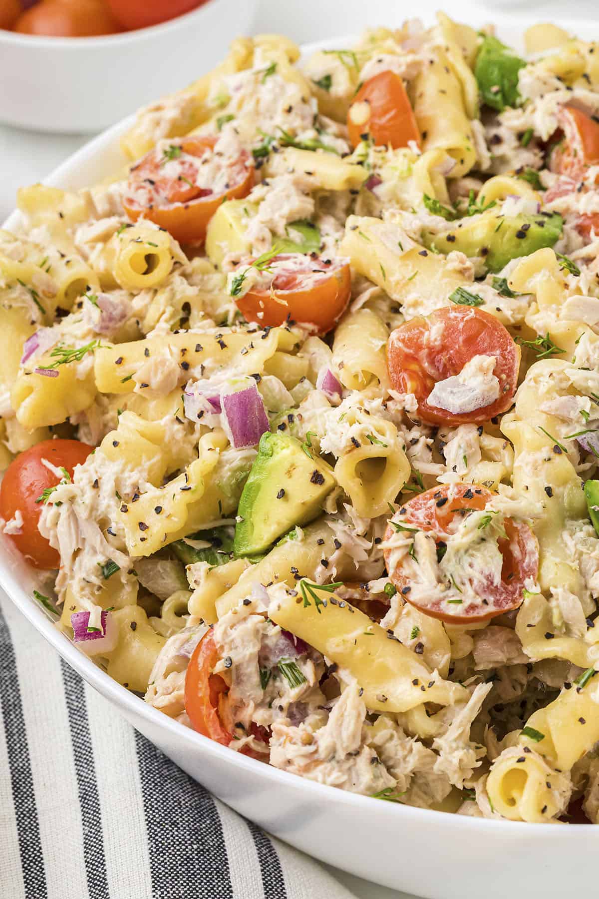 White bowl full of tuna pasta salad recipe.
