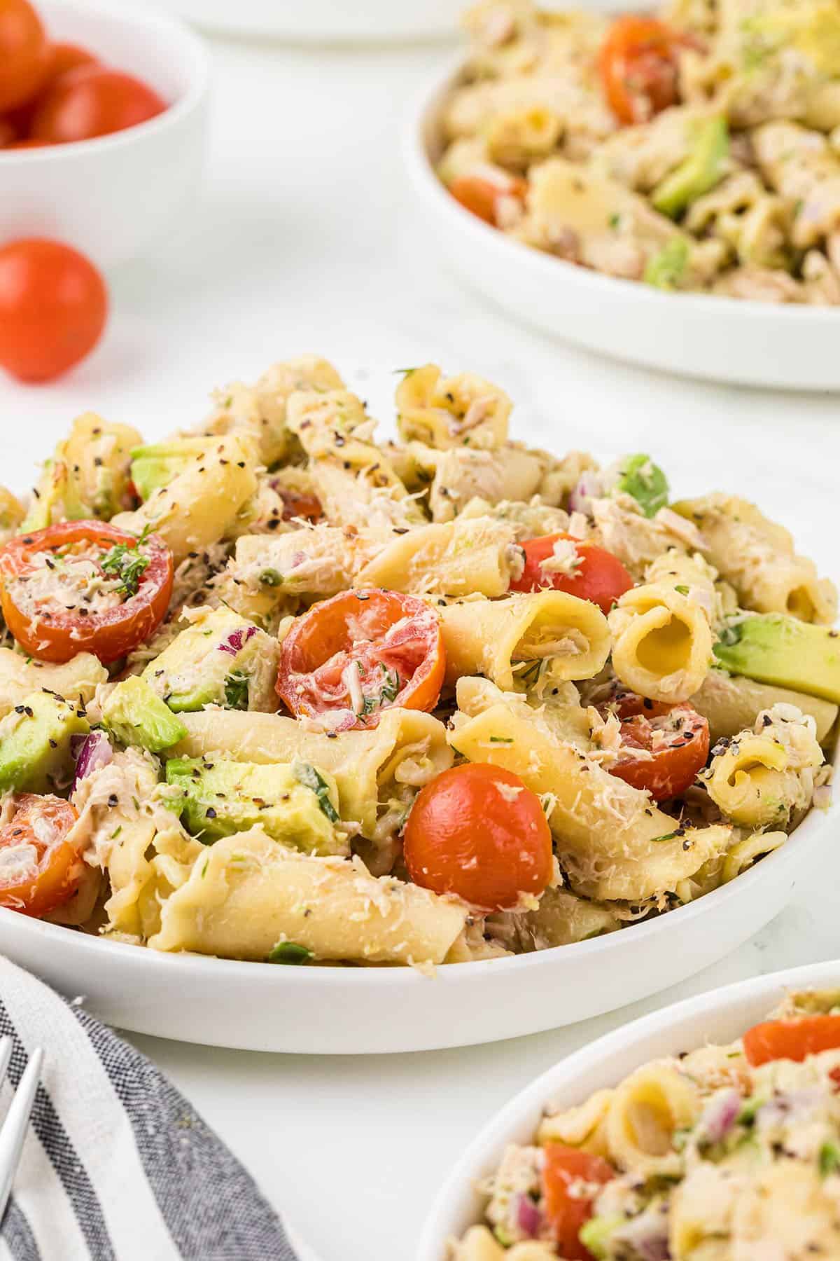 Plate full of tuna pasta salad on white plate.