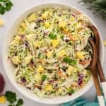 Serving bowl full of pineapple jalapeno coleslaw.