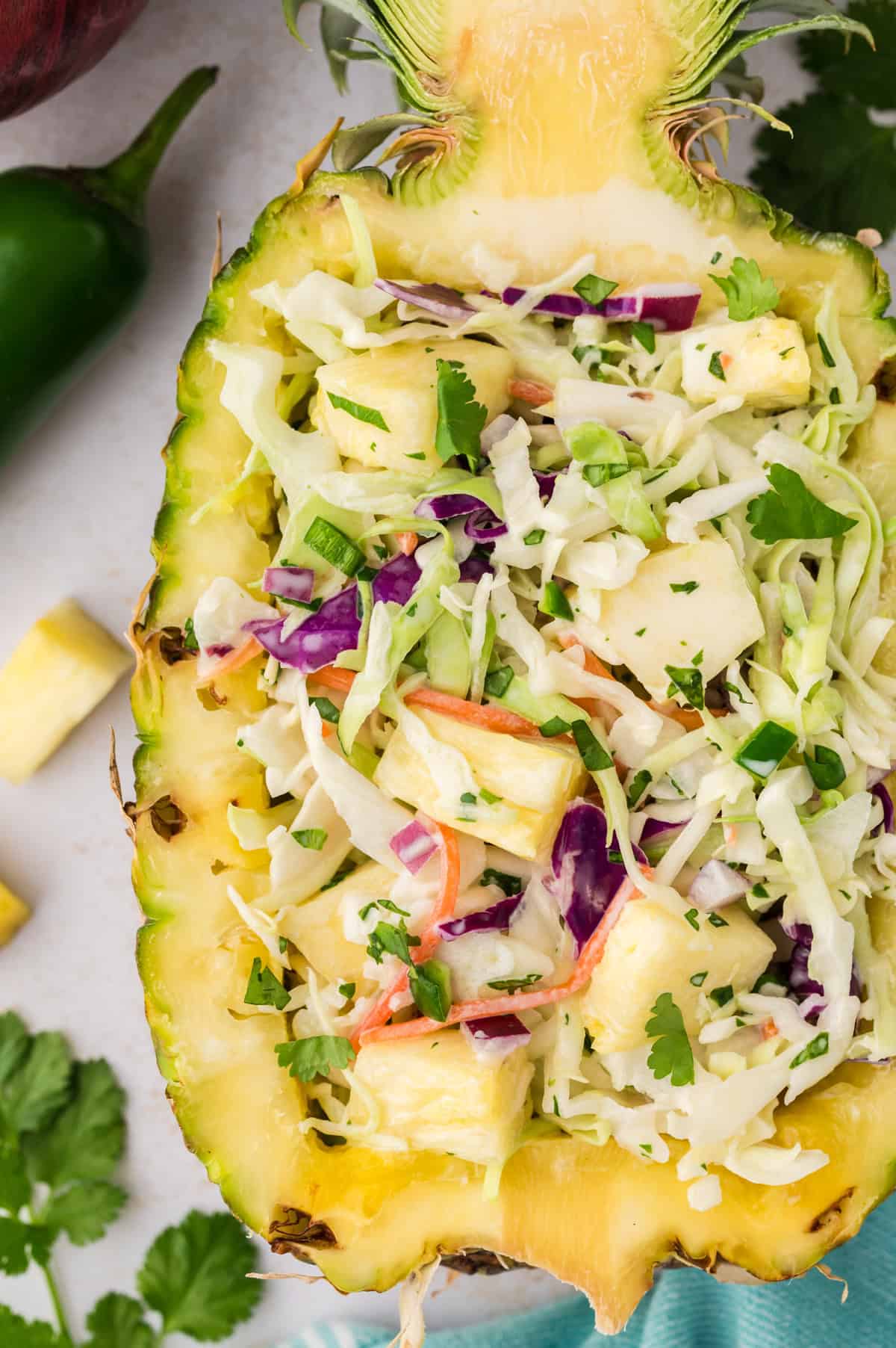 Pineapple coleslaw in a hollowed out pineapple.