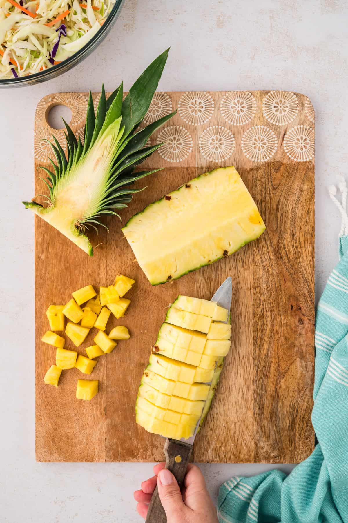 A knife chopping a pineapple.