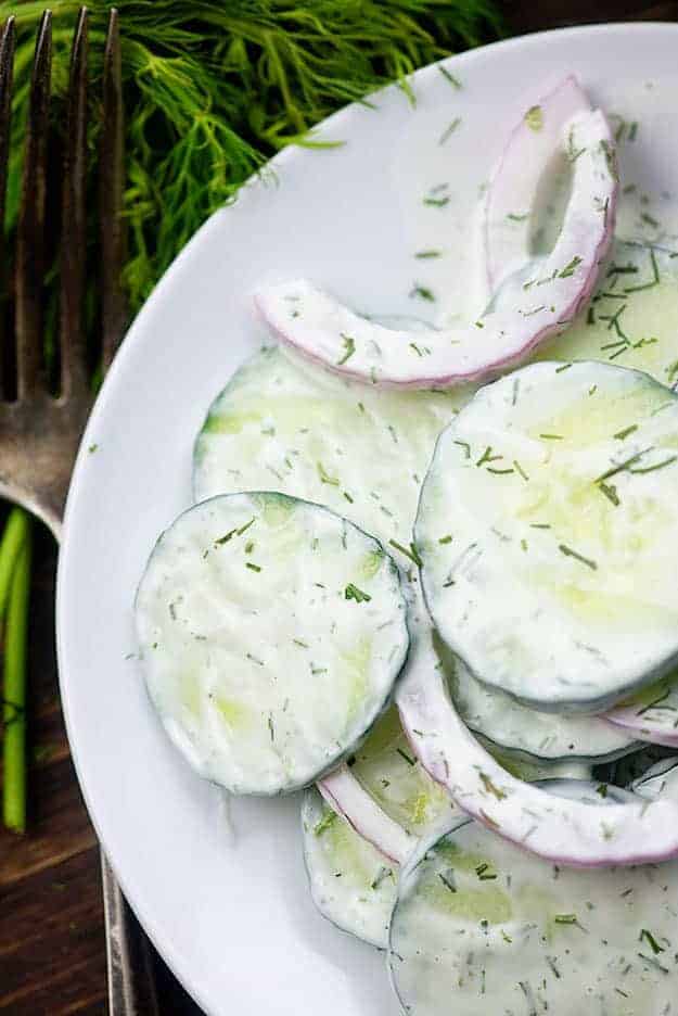 creamy cucumber salad on white plate