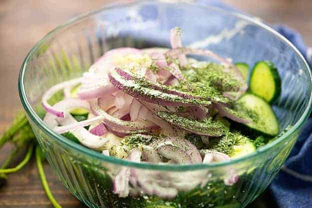 cucumber salad ingredients in glass bowl