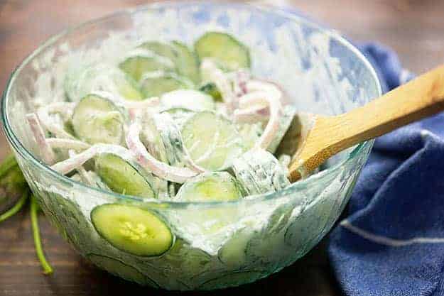 creamy cucumber salad with mayo in glass bowl