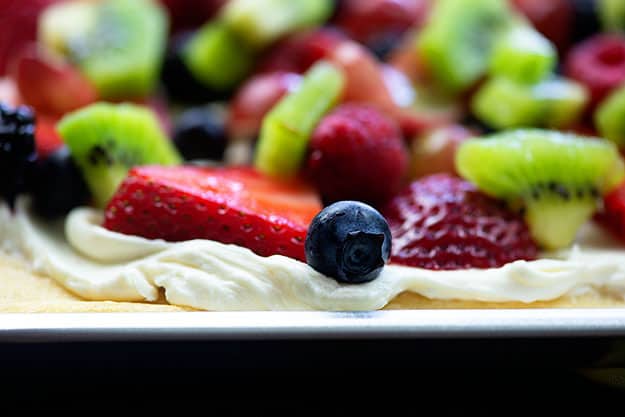 Cream cheese fruit pizza on baking sheet