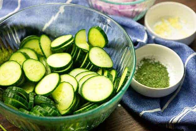 ingredients for cucumber salad in bowls