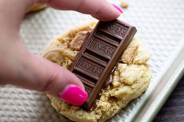 pressing chocolate on warm cookie