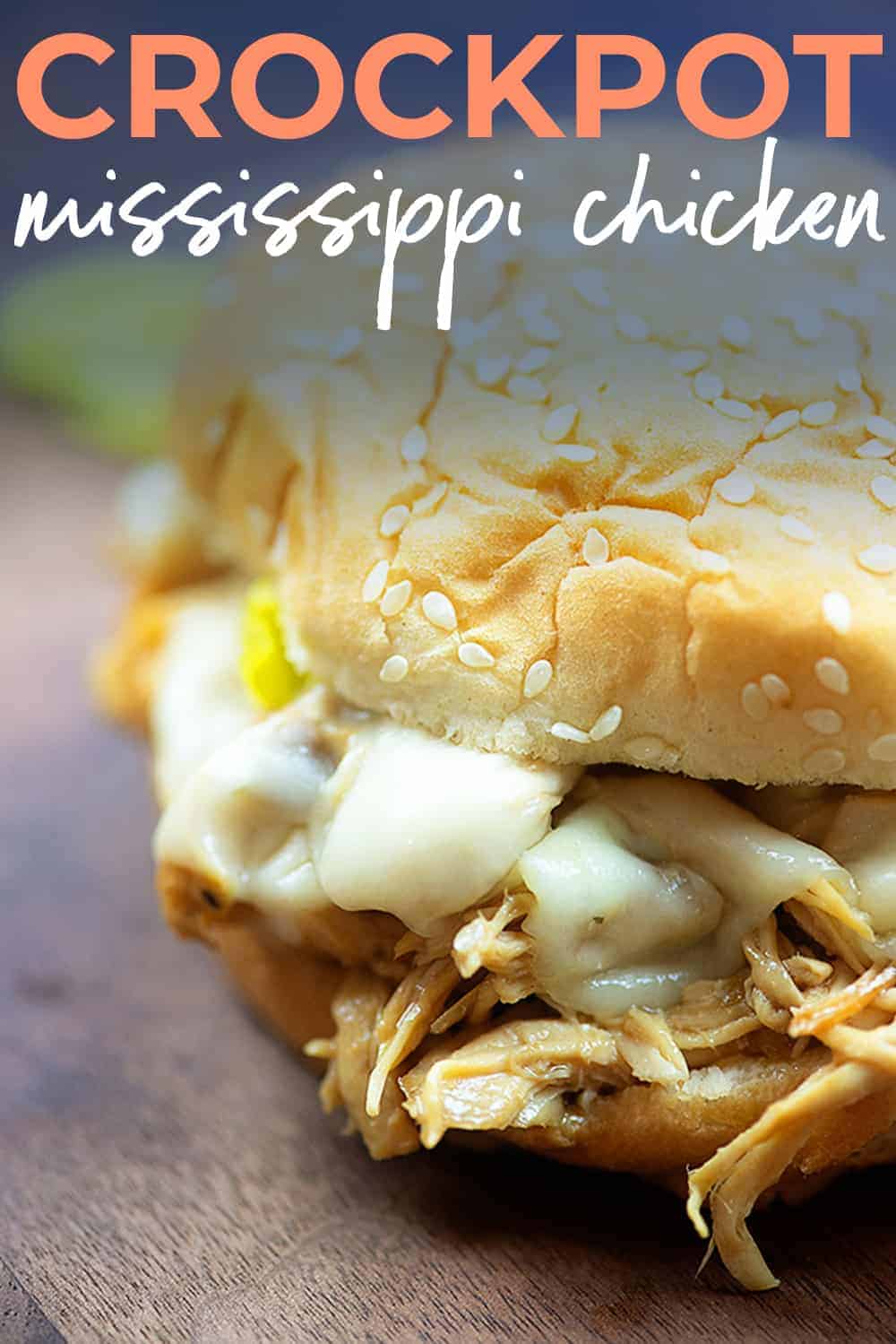 mississippi chicken sandwich on wooden board with text for Pinterest.