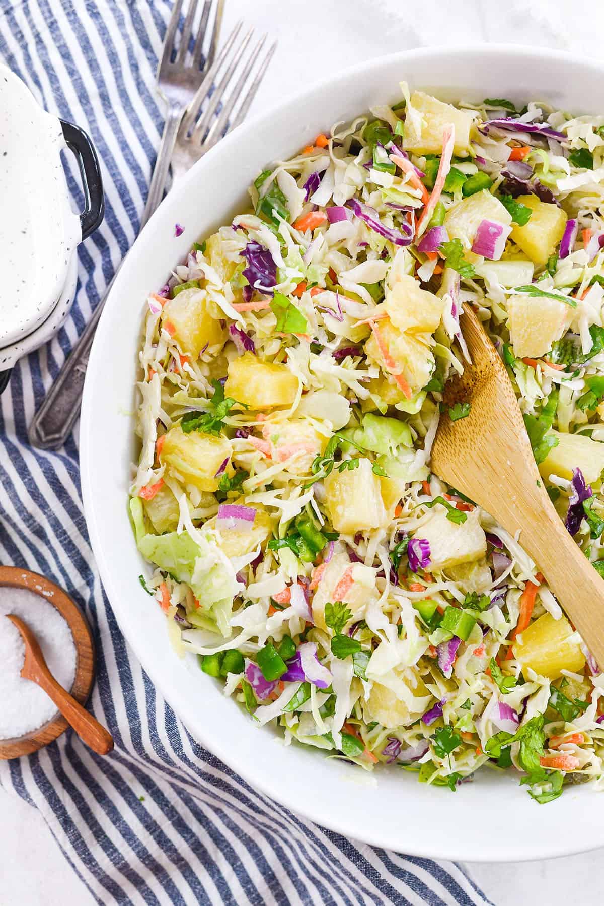 pineapple coleslaw in white bowl.