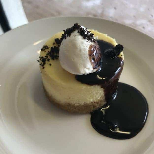 Cheesecake topped with chocolate sauce.