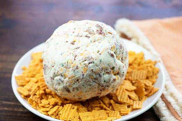 cheese ball rolled in crackers on plate